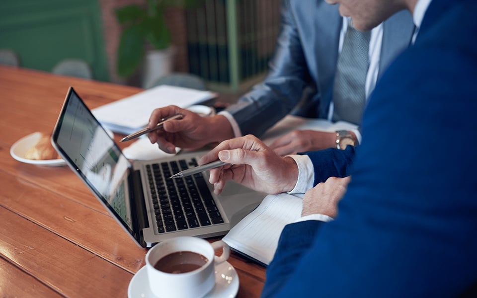 Restaurant owners analysing business performance data and reports for operational insights