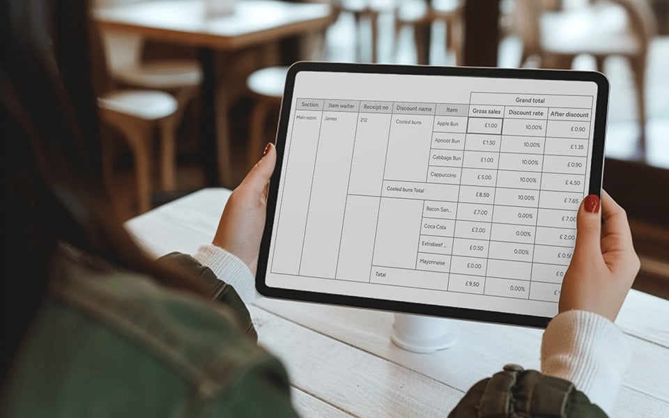 Restaurant owner analyzing cash flow statement and financial performance on tablet