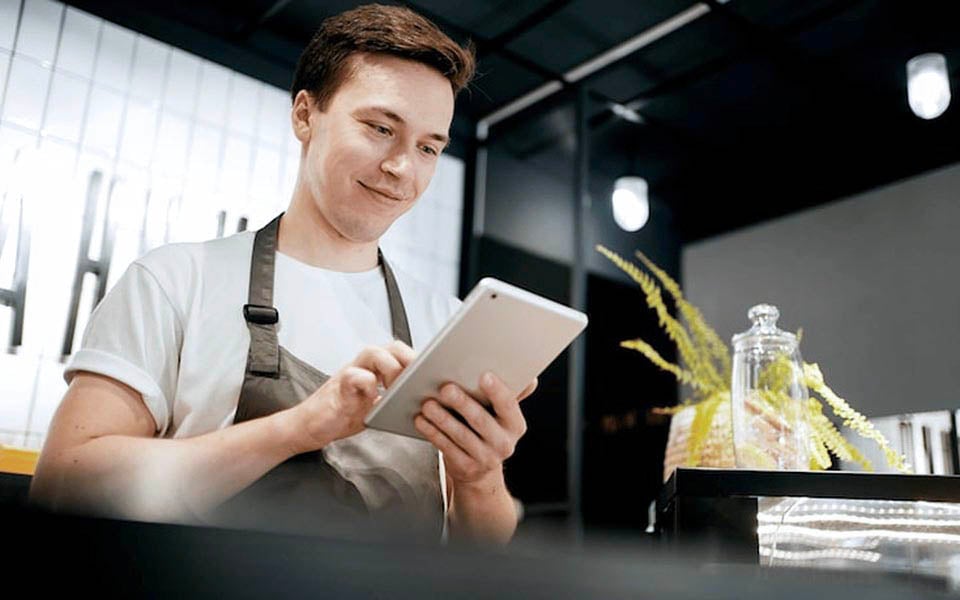 Restaurant manager syncing menus across multiple locations in real time to ensure consistency