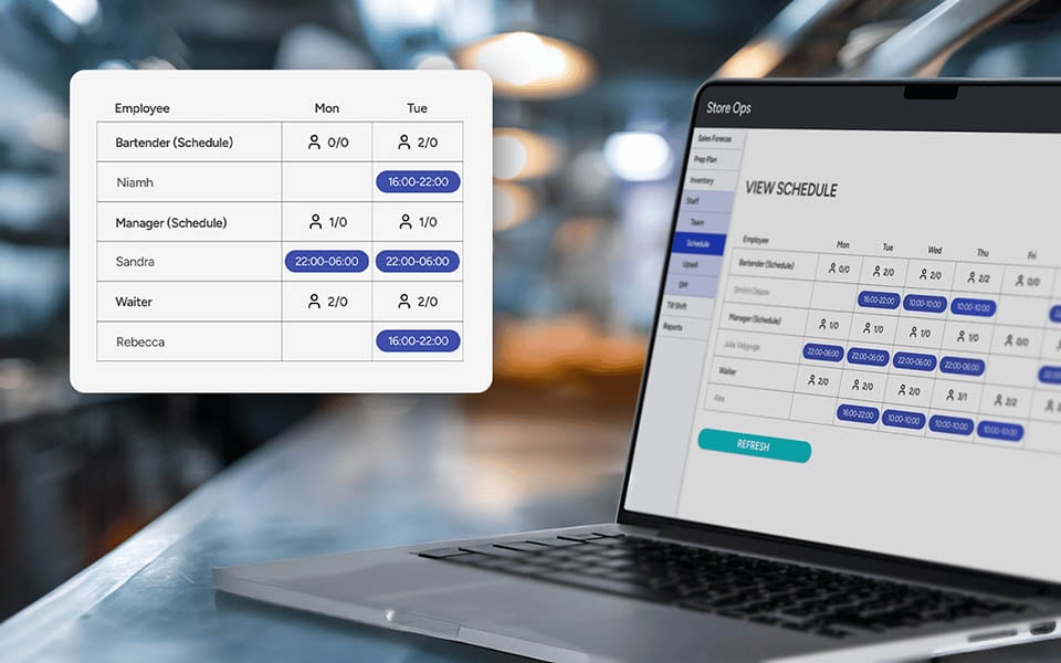 Restaurant manager using staff scheduling and workforce management system on laptop