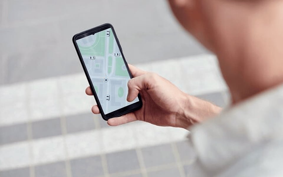 Customer selecting preferred restaurant location in mobile ordering app