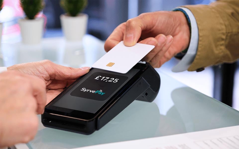 Customer making contactless payment using Syrve Pay on restaurant POS terminal