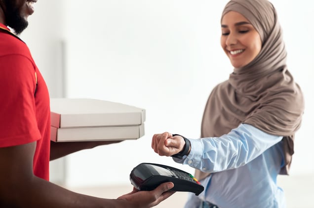 black-delivery-man-holding-pizza-box-and-pos-termi-2023-11-27-05-34-51-utc