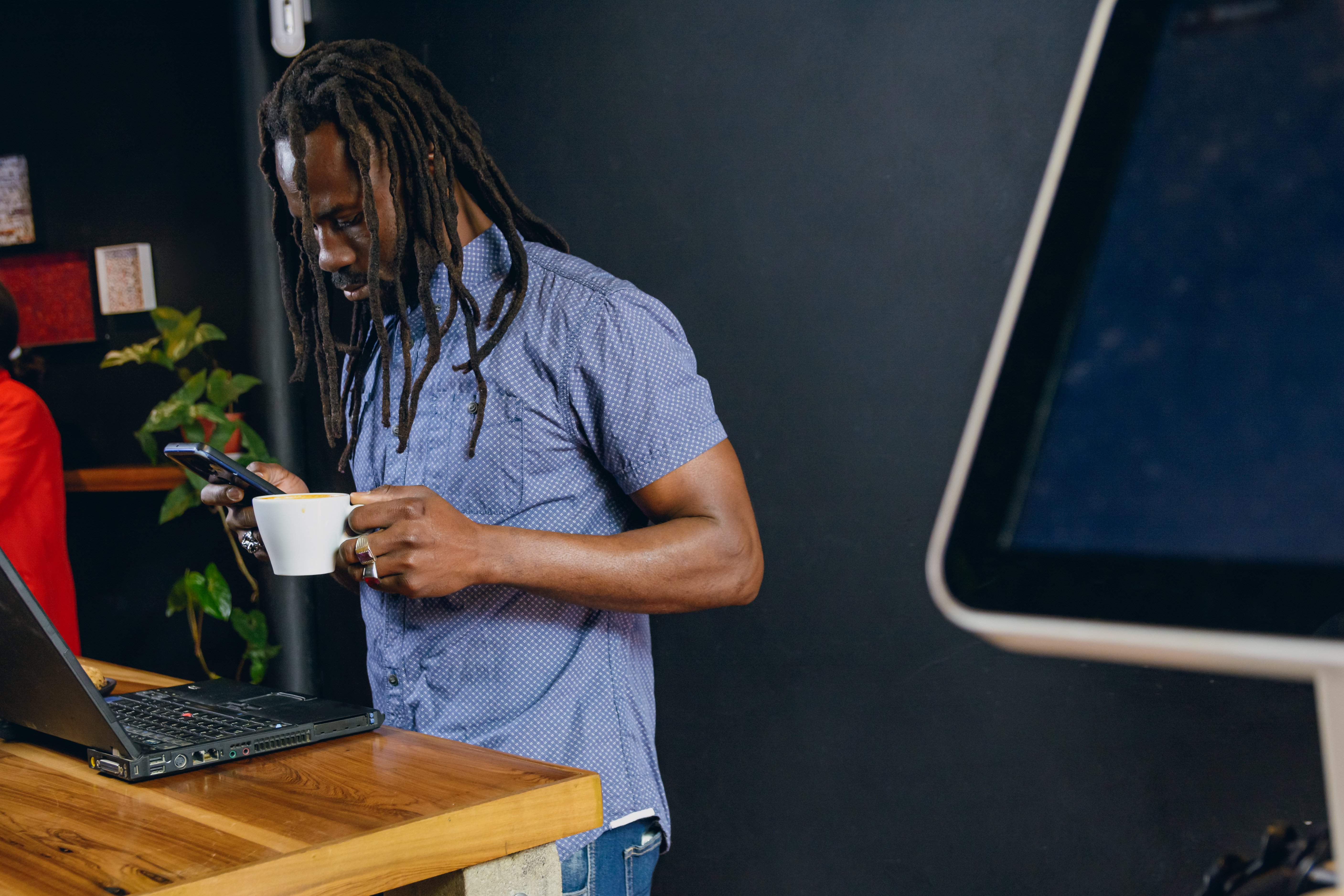 freelance-black-man-with-dreadlocks-inside-cafe-us-2023-11-27-04-56-23-utc