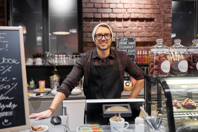 happy-seller-man-or-barman-at-cafe-counter-2023-11-27-05-00-26-utc
