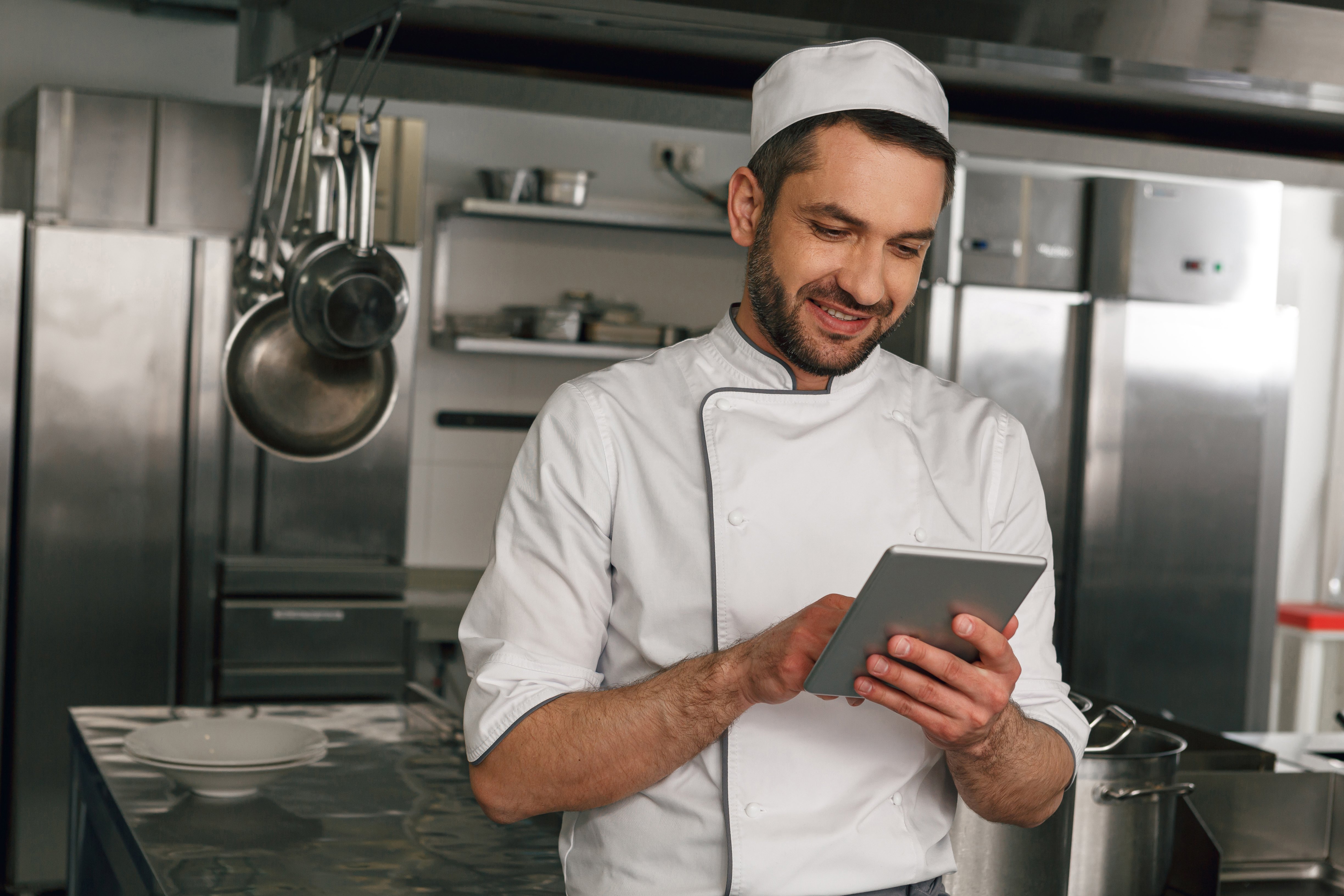 smiling-chef-in-uniform-making-order-in-digital-ta-2023-11-27-05-01-24-utc
