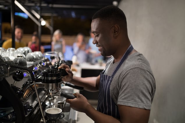 smiling-waiter-making-cup-of-coffee-2023-11-27-05-01-15-utc