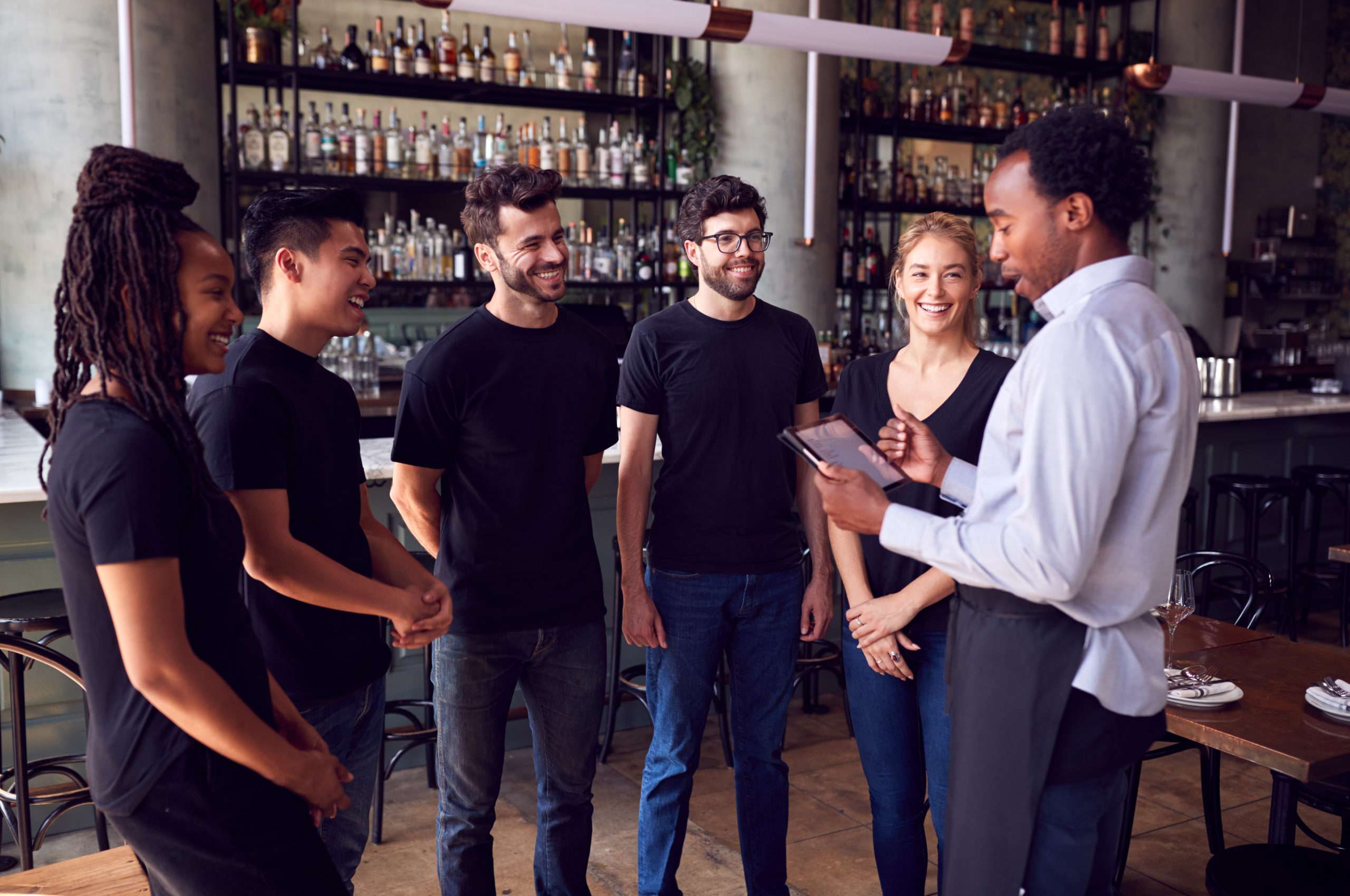 Restaurant staff using Syrve tablet software to discuss pricing